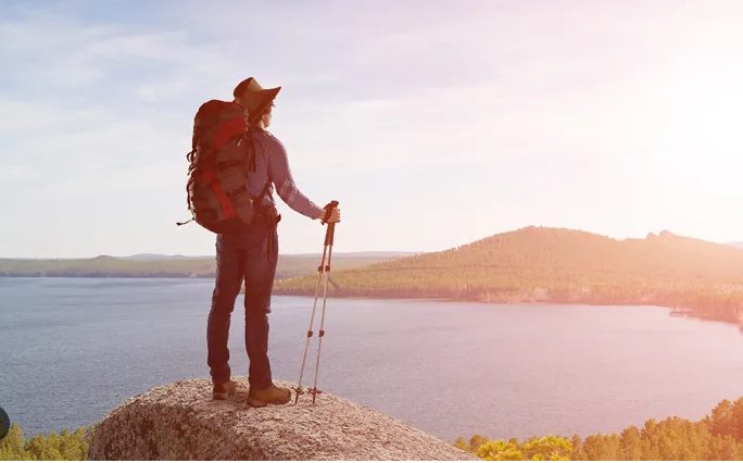 dude hiking looking at lake