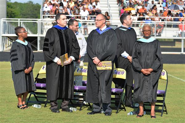 Conferring diplomas at Hampton High's first graduation