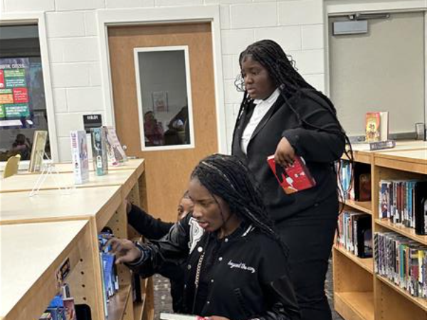 students looking at books